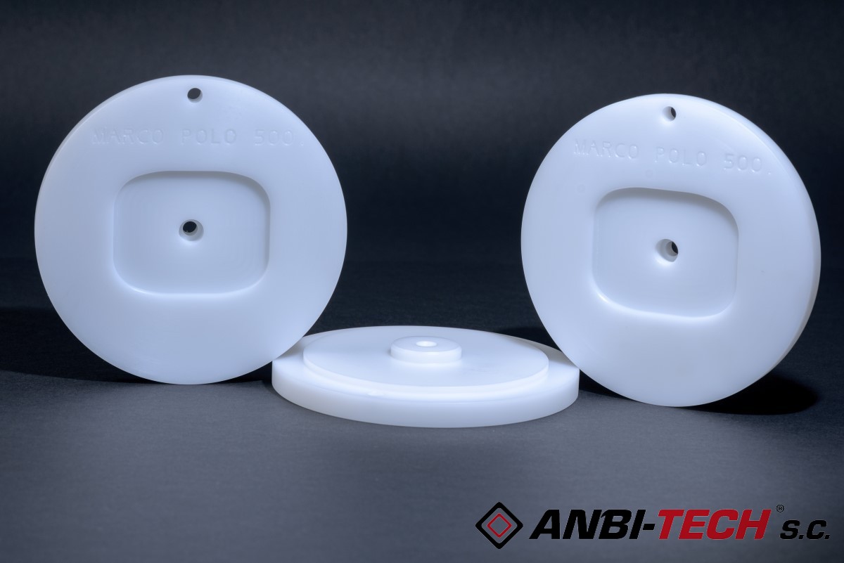 Three white round plastic parts with holes and milled recesses on a black background.