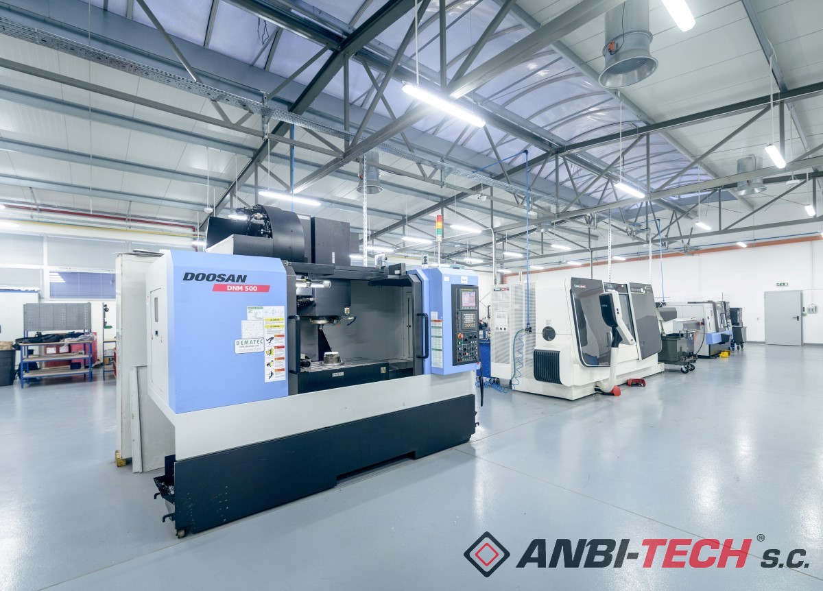 Large, modern CNC machine tools lined up in a clean, bright production hall with a glossy floor.