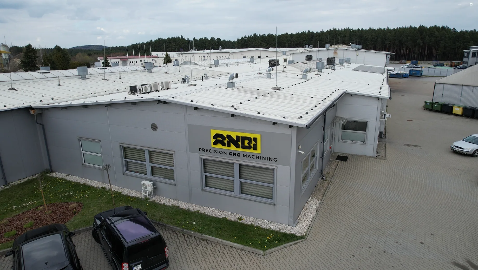 Front of the Anbi-Tech building with the logo and the Precision CNC Machining lettering - headquarters in Olkusz