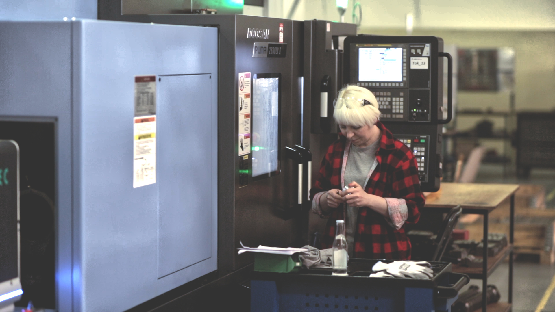 Operator programming a Doosan Puma lathe - Fanuc panel