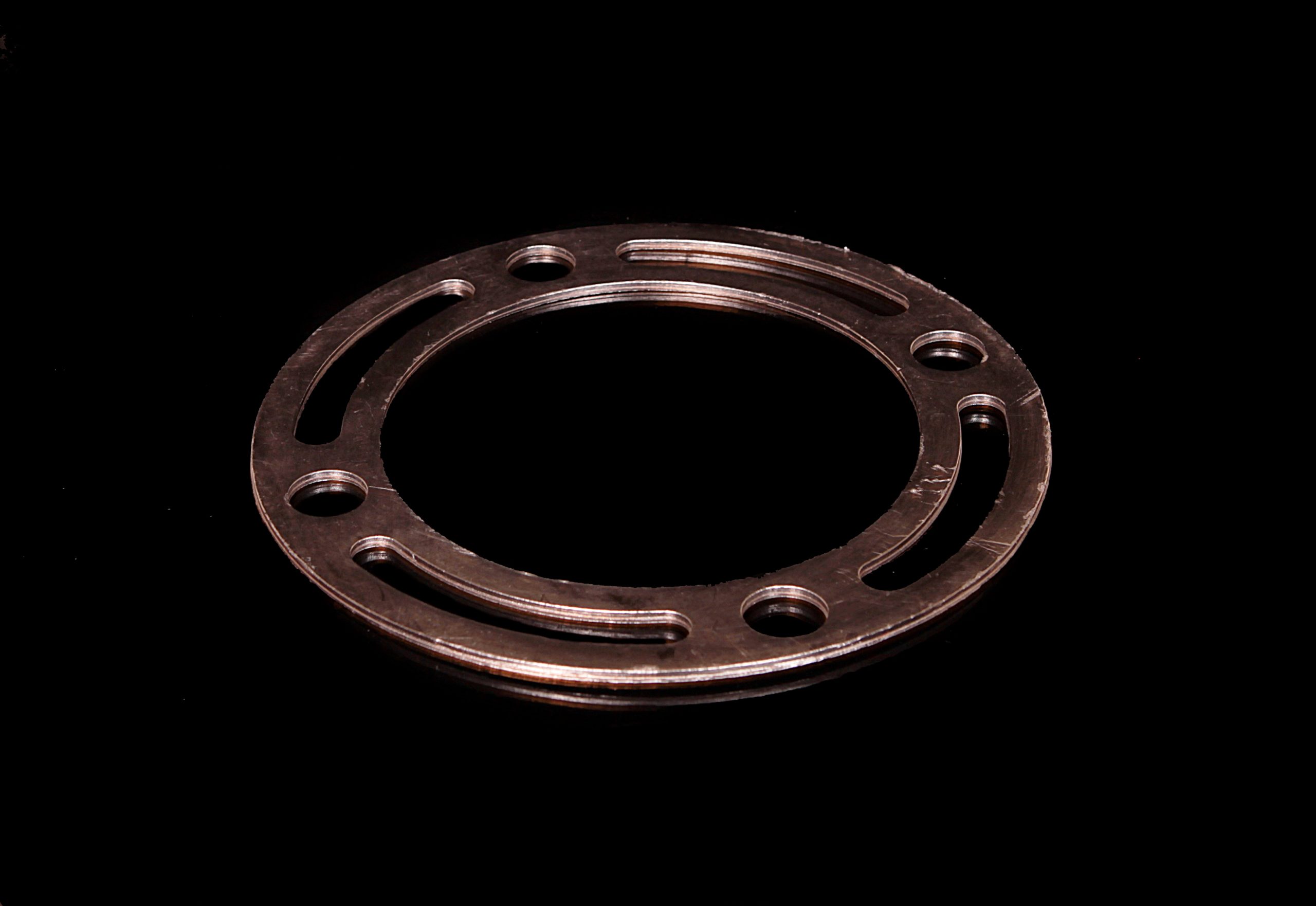 Graphite-metal ring with 4 slot cut-outs and 4 mounting holes - Camprofile type gasket
