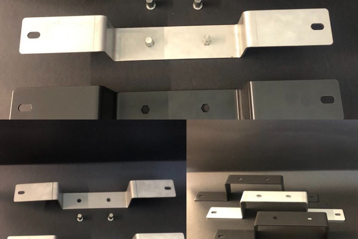 Silver and black profiled metal components with holes and small parts arranged on a dark background.